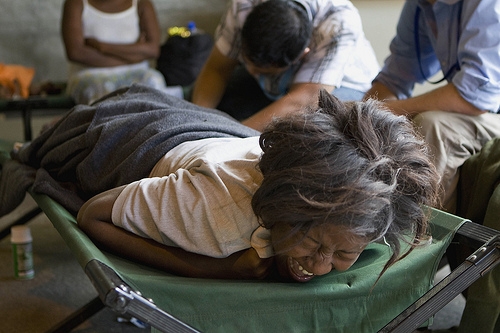 A Haitian woman grimaces while receiving treatment at an ad hoc medical clinic at MINUSTAH's logistics base.